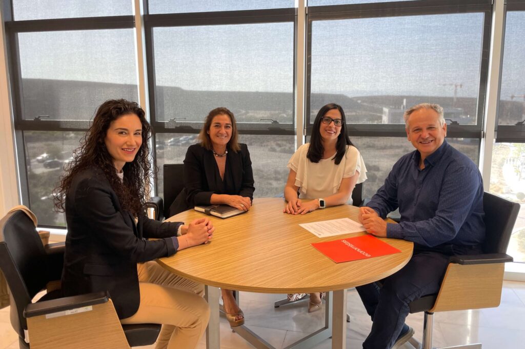 Foto de tres mujeres y un hombre sentados en una mesa